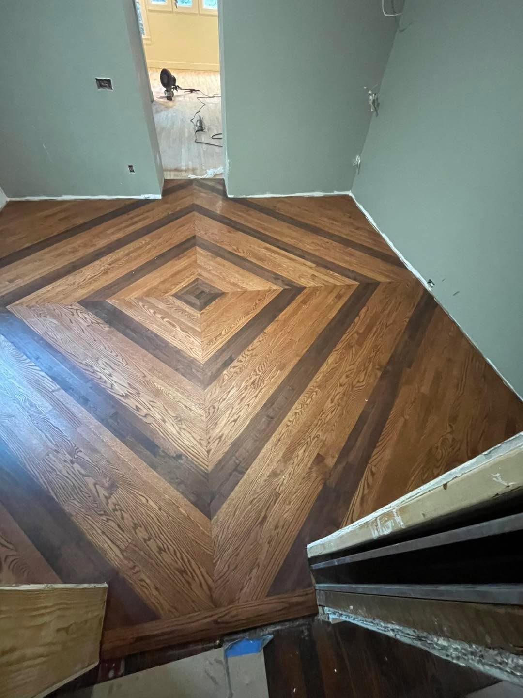 Custom chevron and diamond-pattern hardwood floor in two wood tones