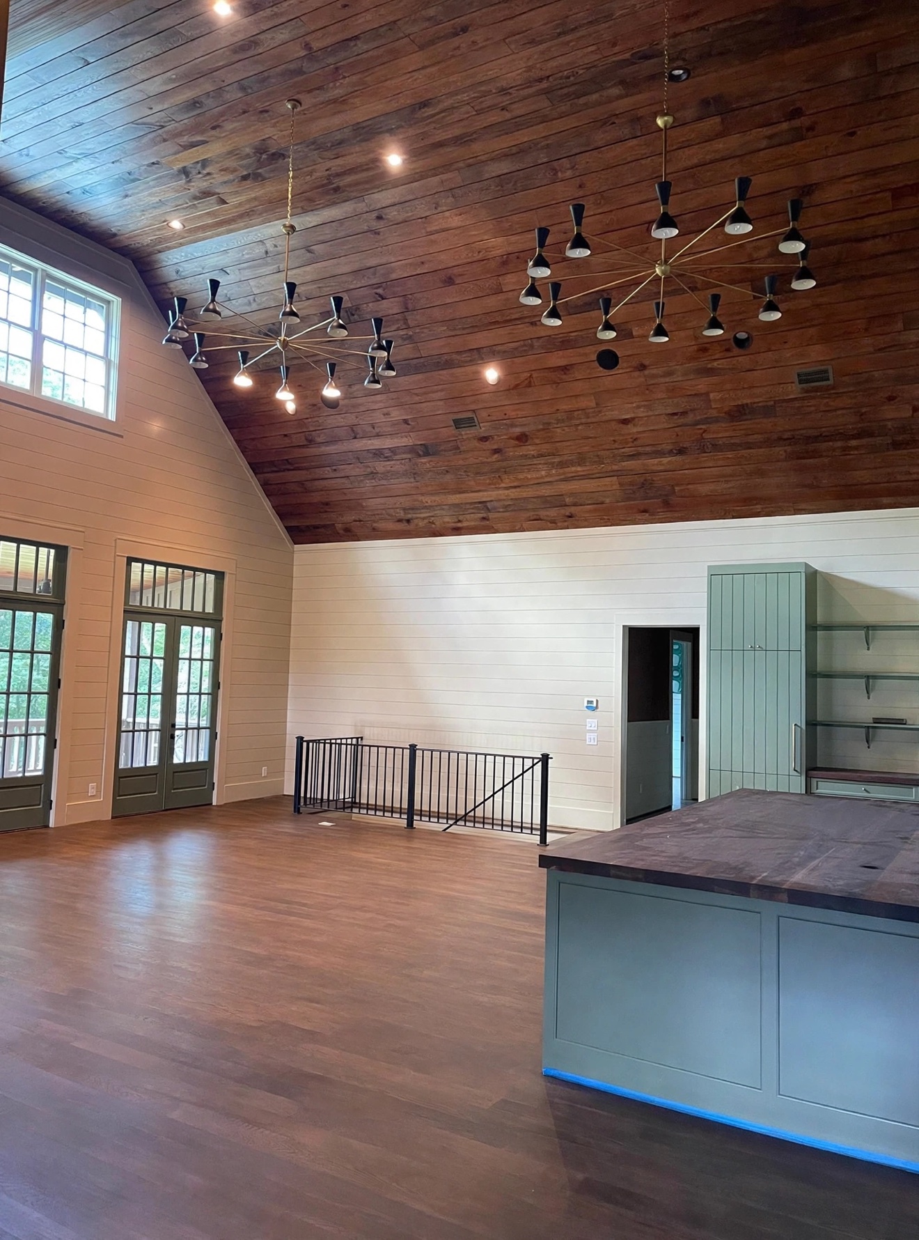 Large open room with wood ceiling and dark hardwood floor