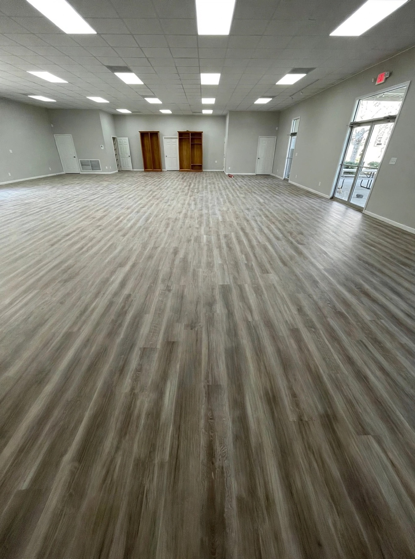 Evenly finished long-plank hardwood floor in a large open room