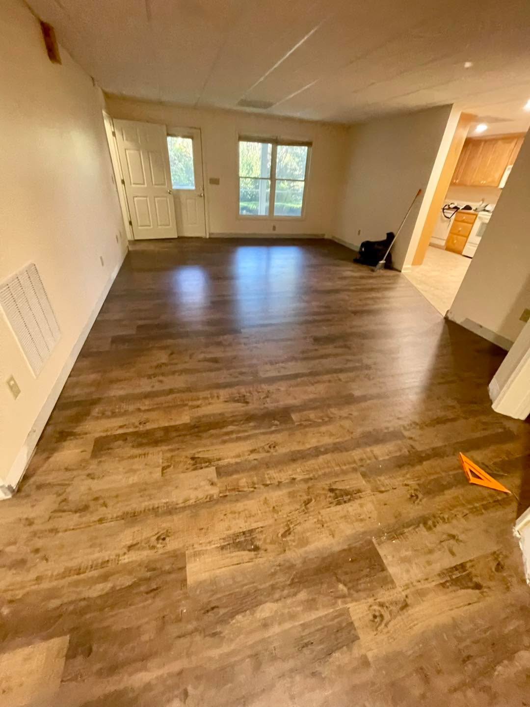 Newly installed dark wood-look plank floor in a living room
