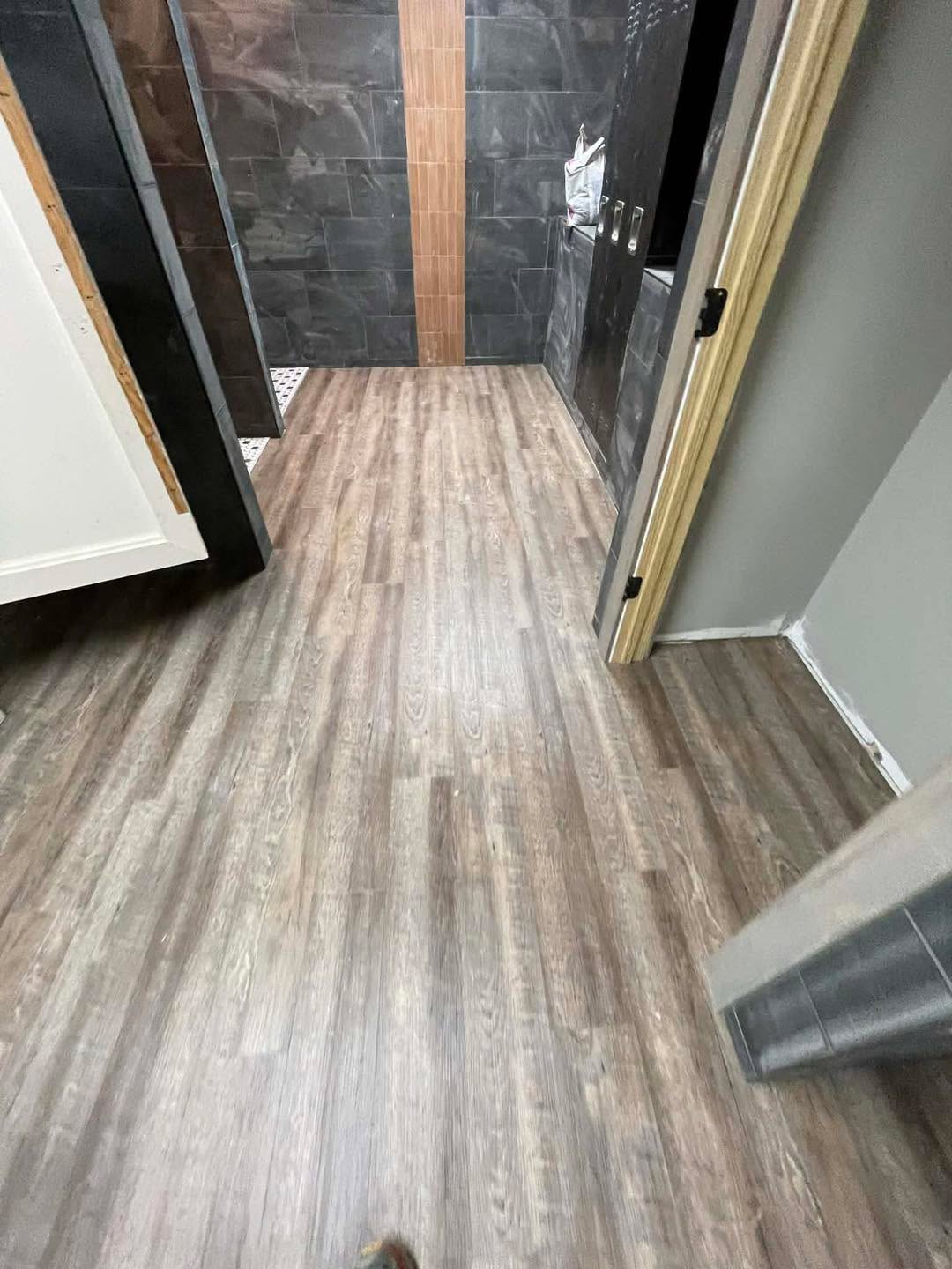 Hallway and room with gray wood-look plank floor
